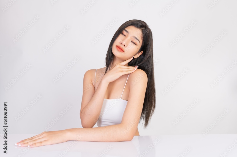 Portrait of a young, smart and very beautiful clean asian sexy female lady wearing white tank top with different elegant poses and emotions against a white studio background