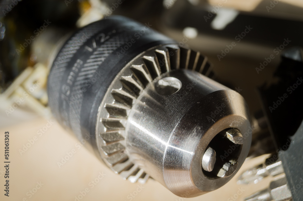 Repair of electric drill. Disassembled working power tools. A drill coming out of standing, in need of repair and replacement of non-serviceable parts. Selective focus Repair of electric drill. Disassembled working power tools. A drill coming out of standing, in need of repair and replacement of non-serviceable parts. Selective focus