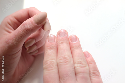  the process of gluing false beige matte long nails