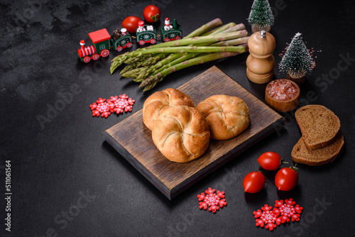 Crusty round bread rolls, known as Kaiser or Vienna rolls on a christmas table