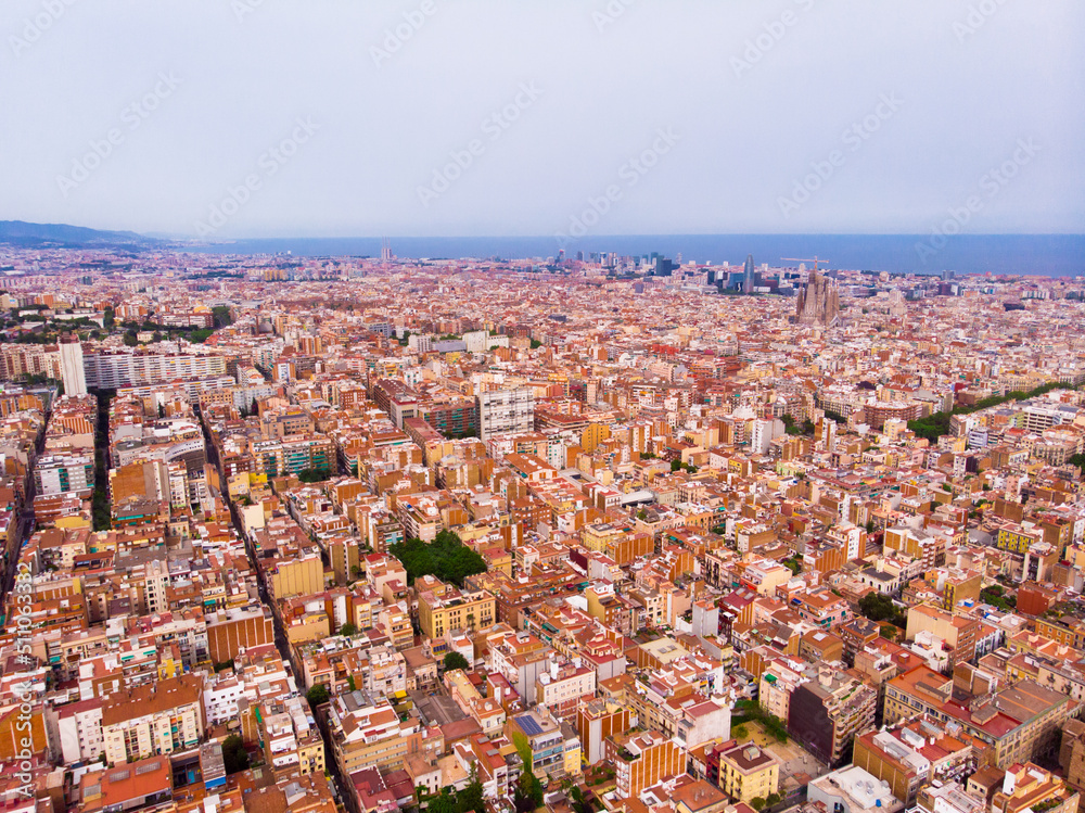 Fototapeta premium mass of roofs of houses on the spanish city of Barcelona
