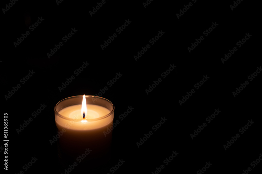 Candle in the dark black background Candle in the dark black background