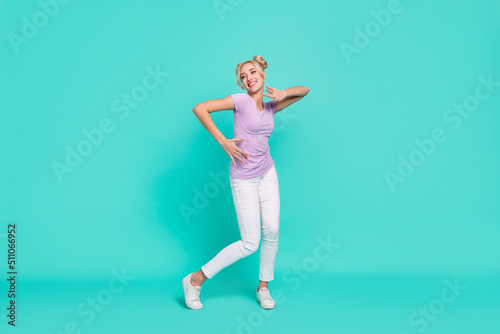 Full length body size view of attractive cheerful carefree girl dancing good mood isolated on teal turquoise color background © deagreez