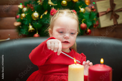 A small child sits the New Year festive table.