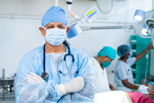 Portriat shot of Confident surgeon at operation theater standing confidently with crossed arms by looking camera - concept of healthcare  professional occupation and medicare.