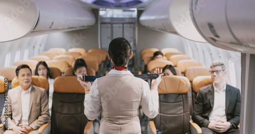 Fototapet Air Hottel is guiding passengers on how to use seat belts.