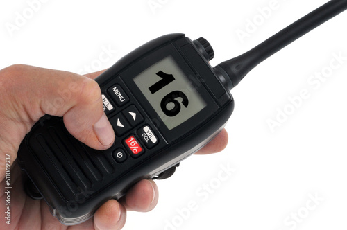 VHF en main branchée sur le canal 16 de la bande marine de fréquence internationale de détresse sur fond blanc photo