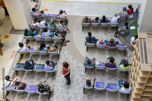 A view from above, many people sitting and sleeping queuing for medicines.