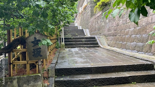 Gentle slope “Women’s” stairway to the shrine of Japanese “Yushima Tenjin”, a historic landmark established all the way in year 458.  Photo taken June 15th year 2022 rainy Tokyo photo