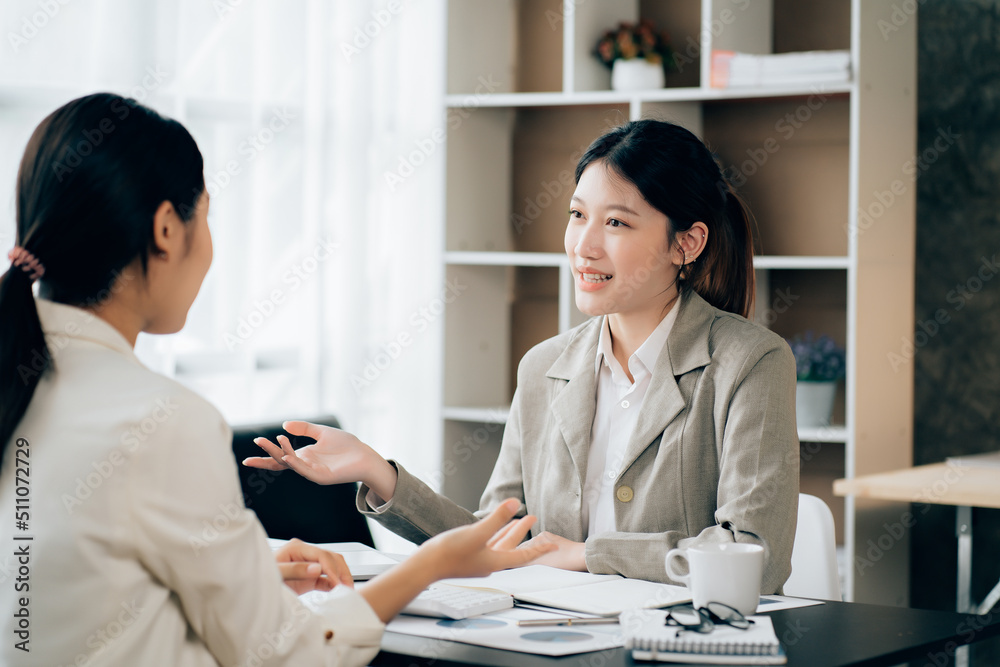 Business women using calculator at working with financial report. Business women using calculator at working with financial report.