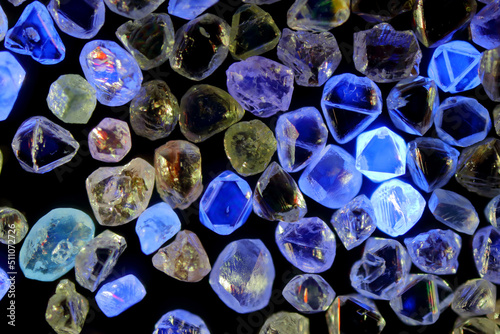 Beautiful fluorescence glow of natural rough diamonds crystal under UV light