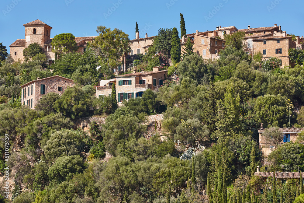 Traditional stone houses and tramuntana mountain range in Deia. Balearic