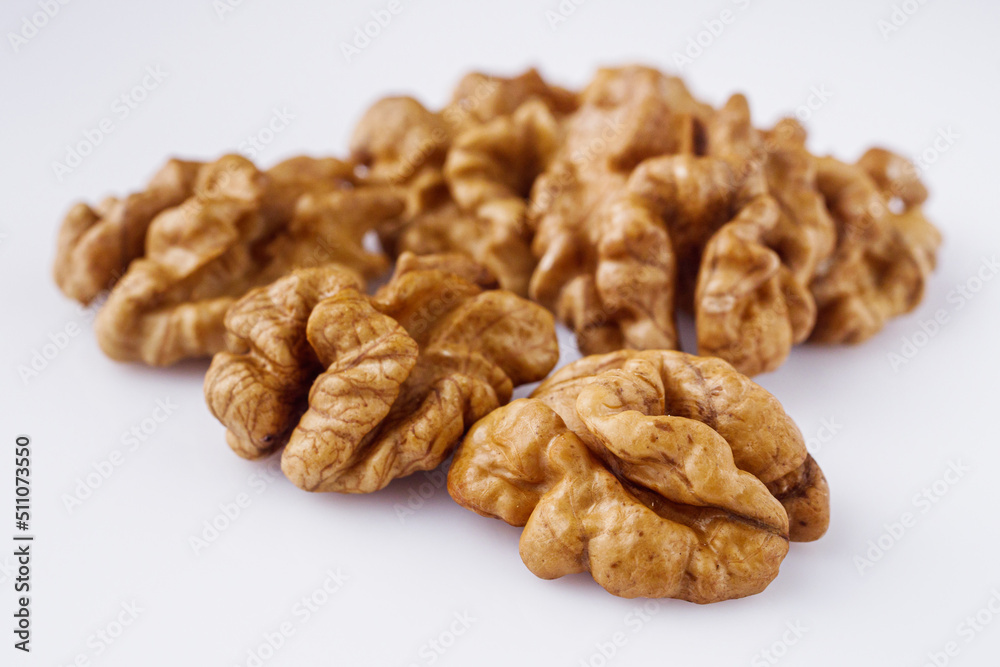 dried walnuts on a white acrylic background dried walnuts on a white acrylic background
