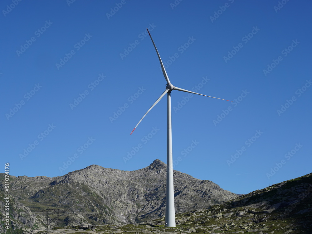 San Gottardo Mountain Pass, Switzerland. A wind turbine working at high mountain. The generator and base of the wind turbines. Renewable energy. Electrical windmills. General contest of green energy San Gottardo Mountain Pass, Switzerland. A wind turbine working at high mountain. The generator and base of the wind turbines. Renewable energy. Electrical windmills. General contest of green energy