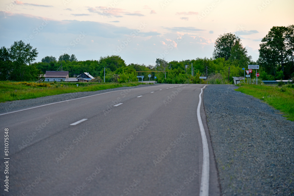 Asphalt road in the forest in the evening Asphalt road in the forest in the evening