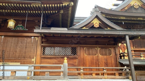 Beautiful wood structure of Japanese honorable shrine main pagoda “Yushima Tenjin” at the east central Tokyo, Shinto landmark established way back in year 458.  Photo taken year 2022 June 15th photo