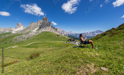 Young man reading a book and relaxing in the mountains