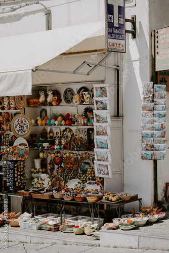 Local market and souvenirs in a town of Ravello, Amalfi Coast, Italy. Handmade ceramic goods, stalls, street on a sunny day  photo