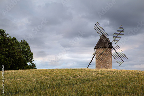 Windmill and wheat field in the French countryside