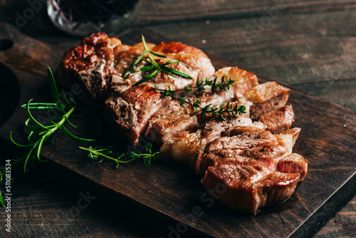 Grilled pork steak on a wooden board