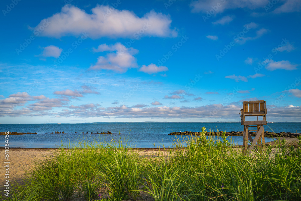 Seascape with the lifeguard bench at sunrise on the Cape Cod beach in Falmouth Shore cove, Massachusetts. Seascape with the lifeguard bench at sunrise on the Cape Cod beach in Falmouth Shore cove, Massachusetts.