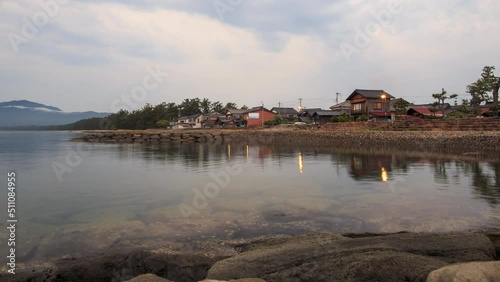 Dawn time lapse of traditional Japanese homes on coast near Amanohashidate photo