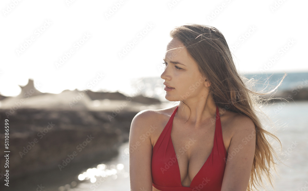 portrait of  a young beautiful woman on a beach