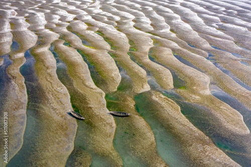 Huge sandbars arise in river Jamuna when the water level drops during the dry season. The striking pattern and textures look like desert when seen from above. Aerial sandbar view. Beauty of Nature. photo