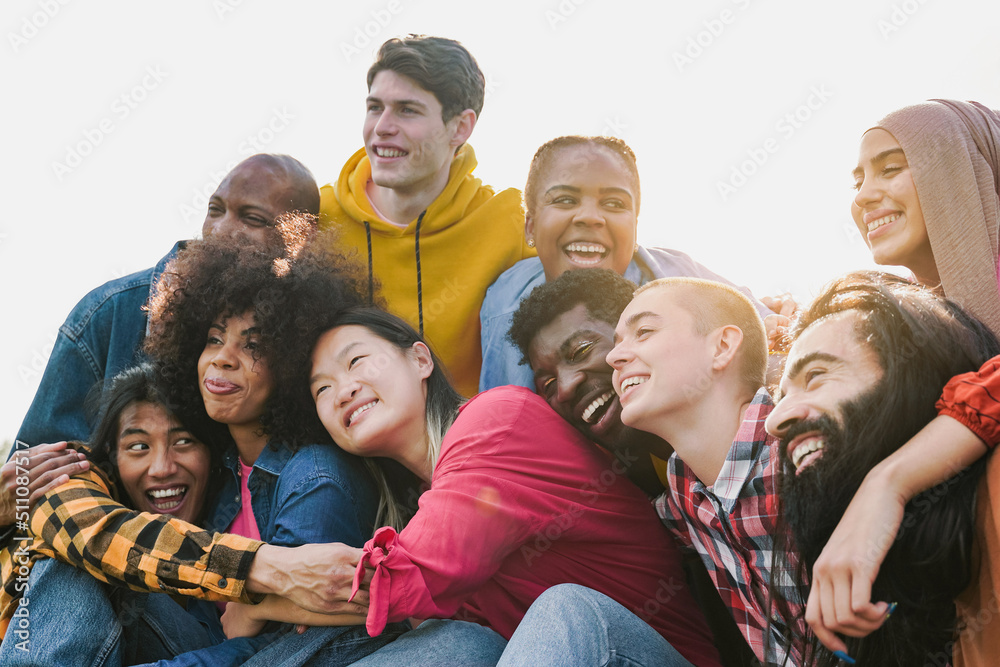 Multiethnic diverse group of people having fun outdoor - Diversity lifestyle concept - Focus on bald girl face