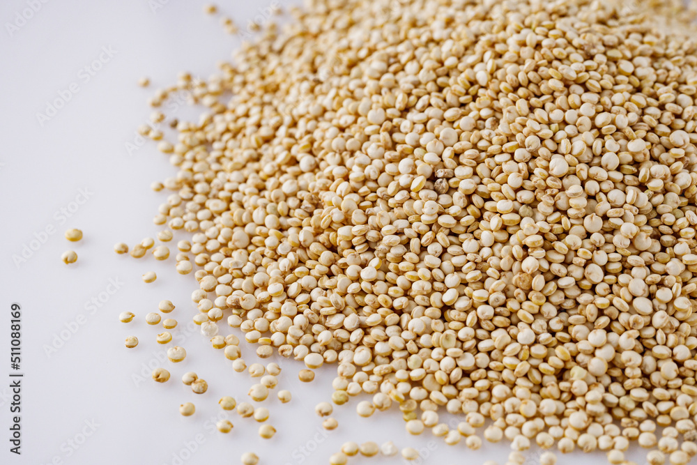 white quinoa seeds on a white acrylic background