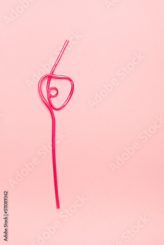 Pink straw on pink background. Summer concept.