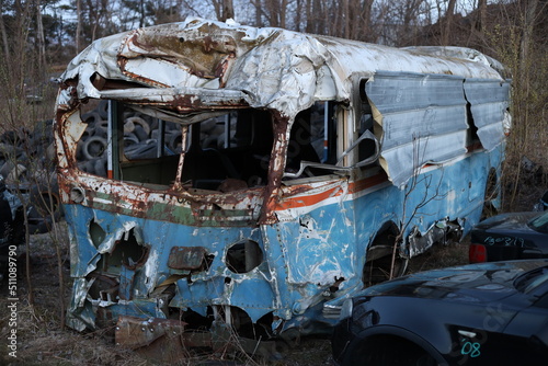 old decaying and eroded bus in the junkyard