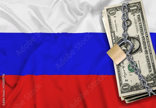 Dollars, lock on the background of the Russian flag. Monetary crisis, financial problems, sanctions, default. The concept is up-to-date relevant situation in economics and politics.