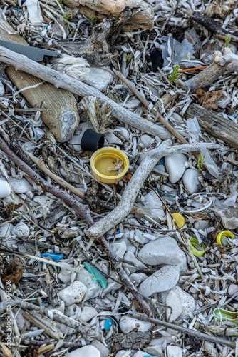 Obraz na płótnie Plastic bottles and waste washed up on a beach by the incoming tide, covering the entire beach w salonie