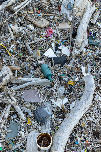 Obraz na płótnie Plastic bottles and waste washed up on a beach by the incoming tide, covering the entire beach w salonie