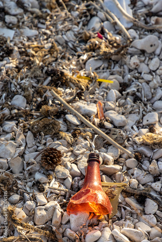 Obraz na płótnie Plastic bottles and waste washed up on a beach by the incoming tide, covering the entire beach w salonie