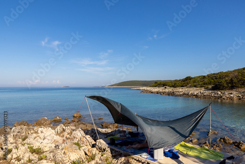 Obraz na płótnie woman lying under awning on the coast of island Molat in Croatia w salonie