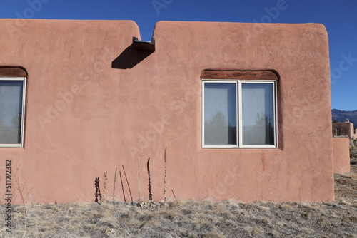 pueblo style home exterior with windows