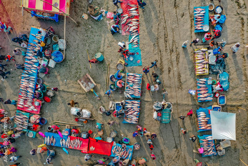 Aerial view of traditional village fair in Bangladesh. Colorful tents of temporary shops make it look like blocks of tetris game. Portable ferris wheel