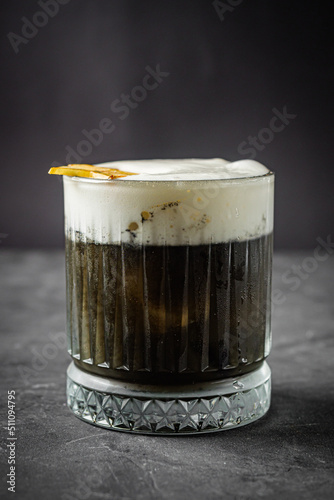 bright colored alcoholic cocktail on a black stone background