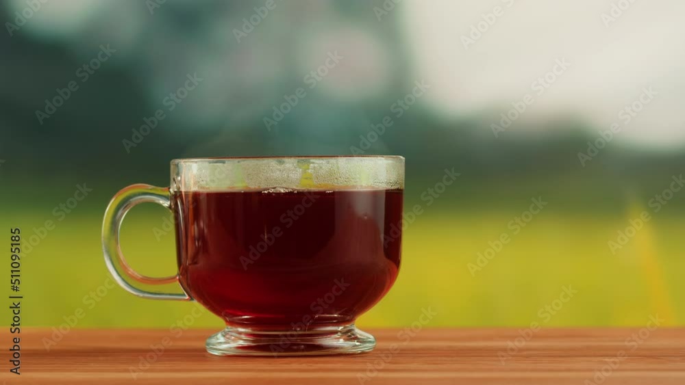 Red fruit tea in glass cup on a wooden table. Hibiscus tea ceremony process, healthy morning, freshly brewed detox drink. Red fruit tea in glass cup on a wooden table. Hibiscus tea ceremony process, healthy morning, freshly brewed detox drink.