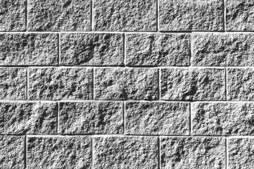 фотографія white painted alley cinder block brick wall building exterior shadows