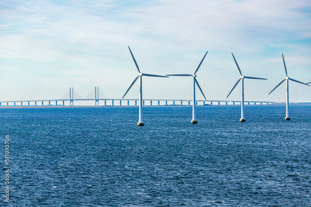 The Middelgrunden offshore wind farm in the Øresund near Copenhagen, Denmark - Øresund Bridge between Copenhagen and Malmo, Sweden is in the background