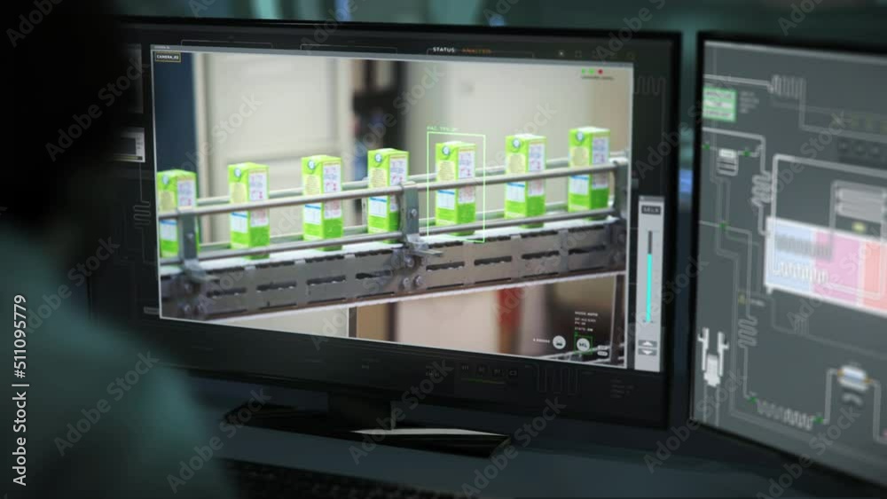 Engineer Uses High Tech Program To Monitor Product Manufacturing Process. Factory Program For Automated Product Manufacturing. Observing Products Manufacturing With Computer Program. Production Line Engineer Uses High Tech Program To Monitor Product Manufacturing Process. Factory Program For Automated Product Manufacturing. Observing Products Manufacturing With Computer Program. Production Line