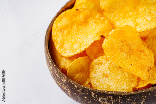 golden crispy potato chips on a white background