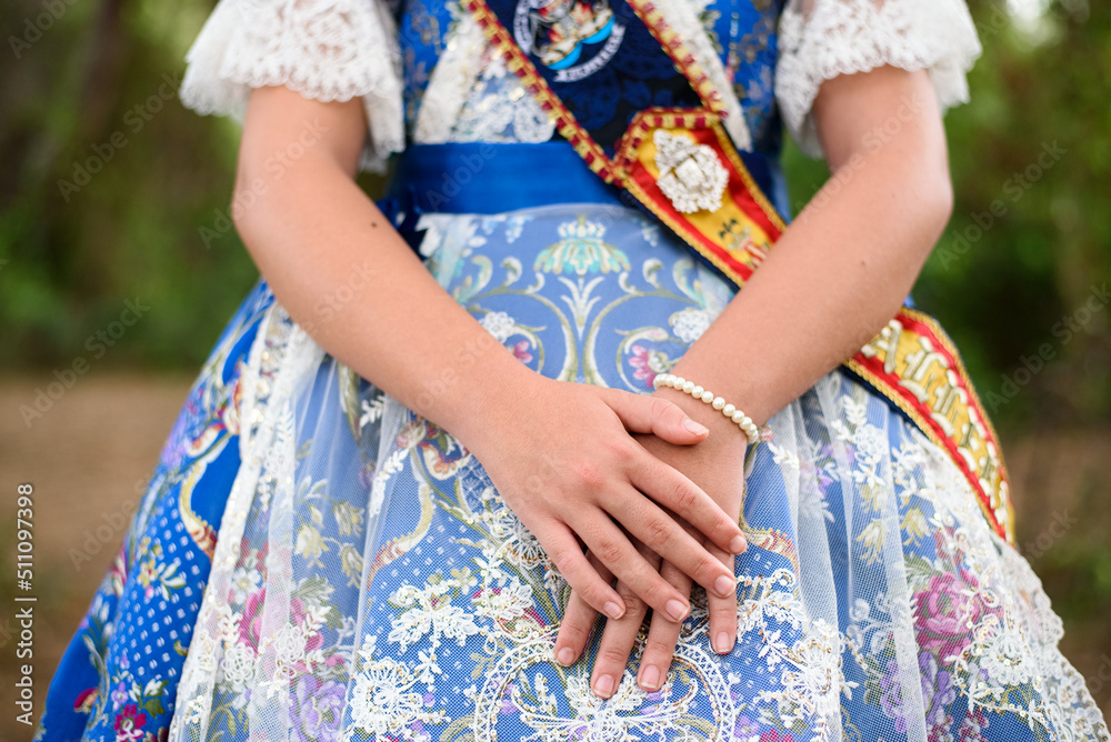 Detail of a traditional Valencian fallera dress, with beautiful embroidery, crossed hands.