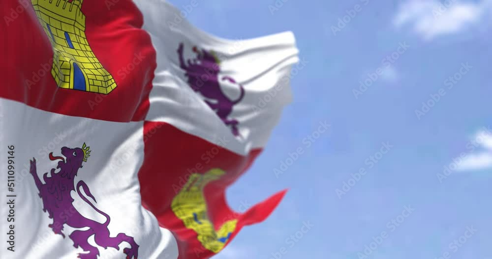 The Castile and Leon flag waving in the wind on a clear day.