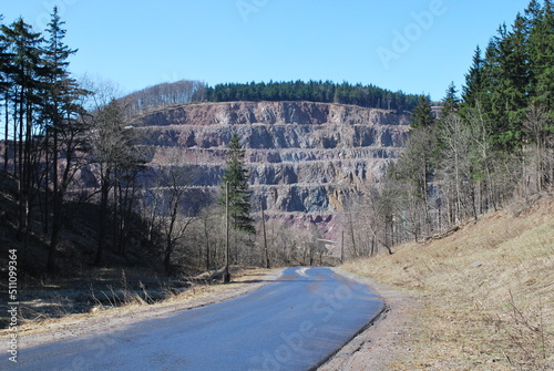 melaphyre quarry, view of the excavation, you can see the road from which the photo was taken and the surroundings, slopes and trees photo