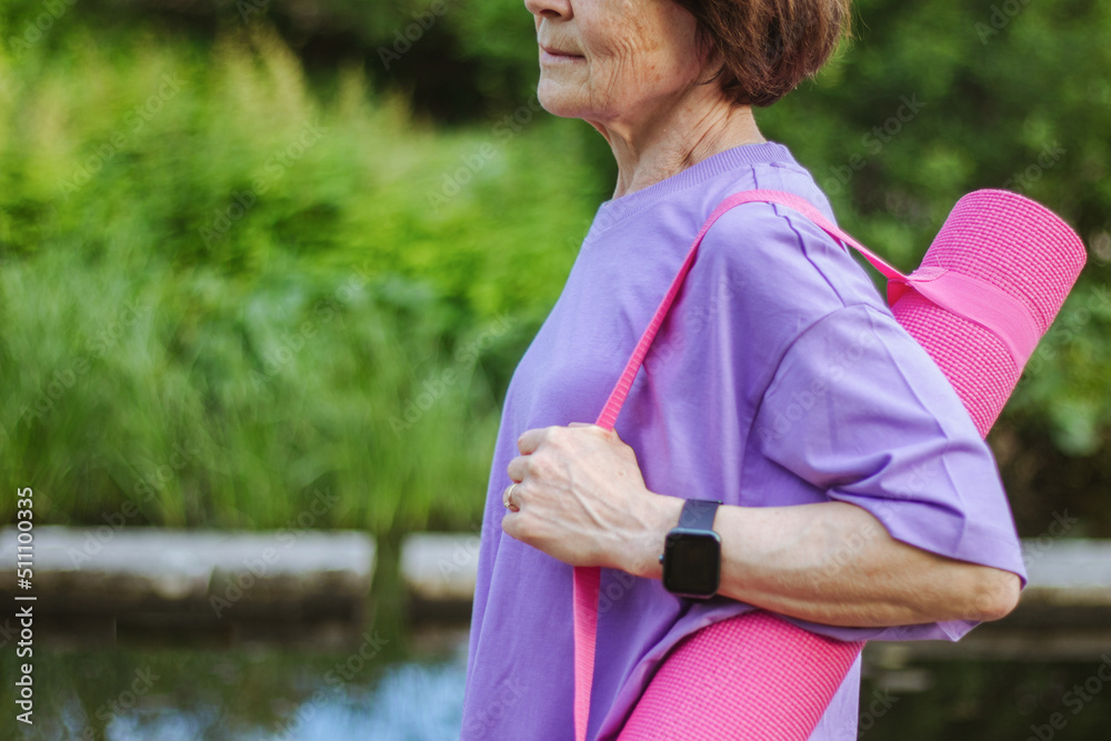 An old slender woman does yoga in the park An old slender woman does yoga in the park