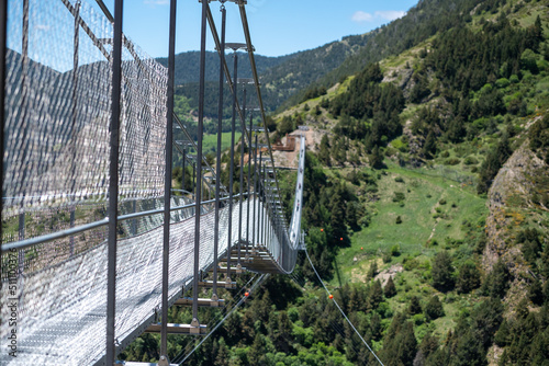 People walking on the longest Tibetan bridge in Europe  600 meters long and 200 meters high in the Parish of Canillo in Andorra.